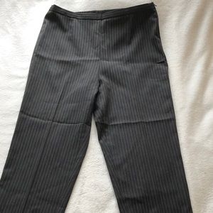 Black trousers with green accent stitching.